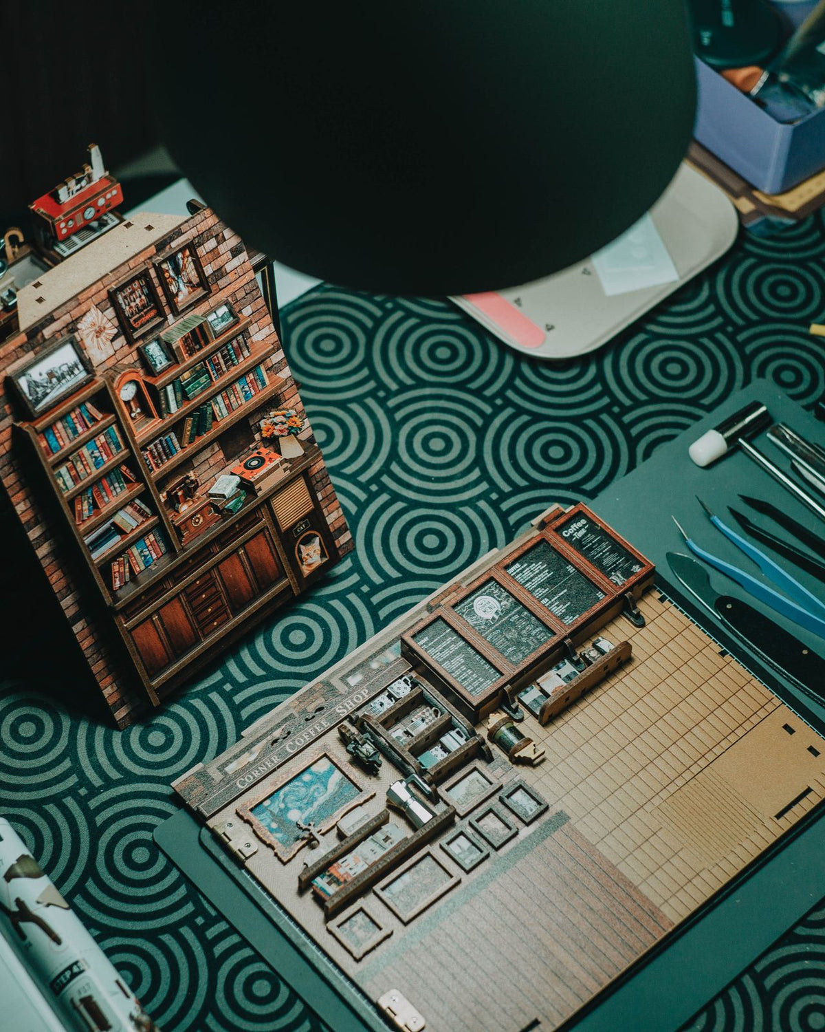 Building a DIY miniature house kit – wooden pieces, tools and a finished tiny bookshop