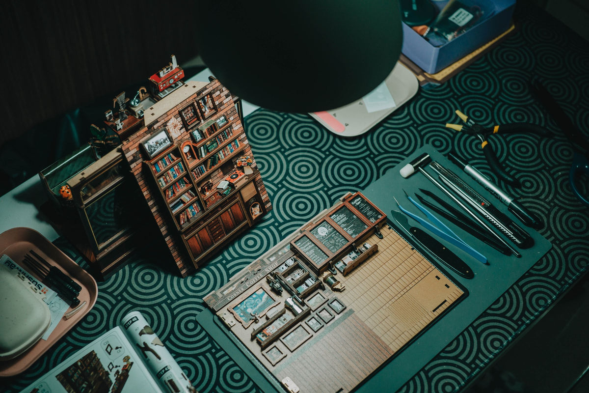 Building a DIY miniature house kit – wooden pieces, tools and a finished tiny bookshop