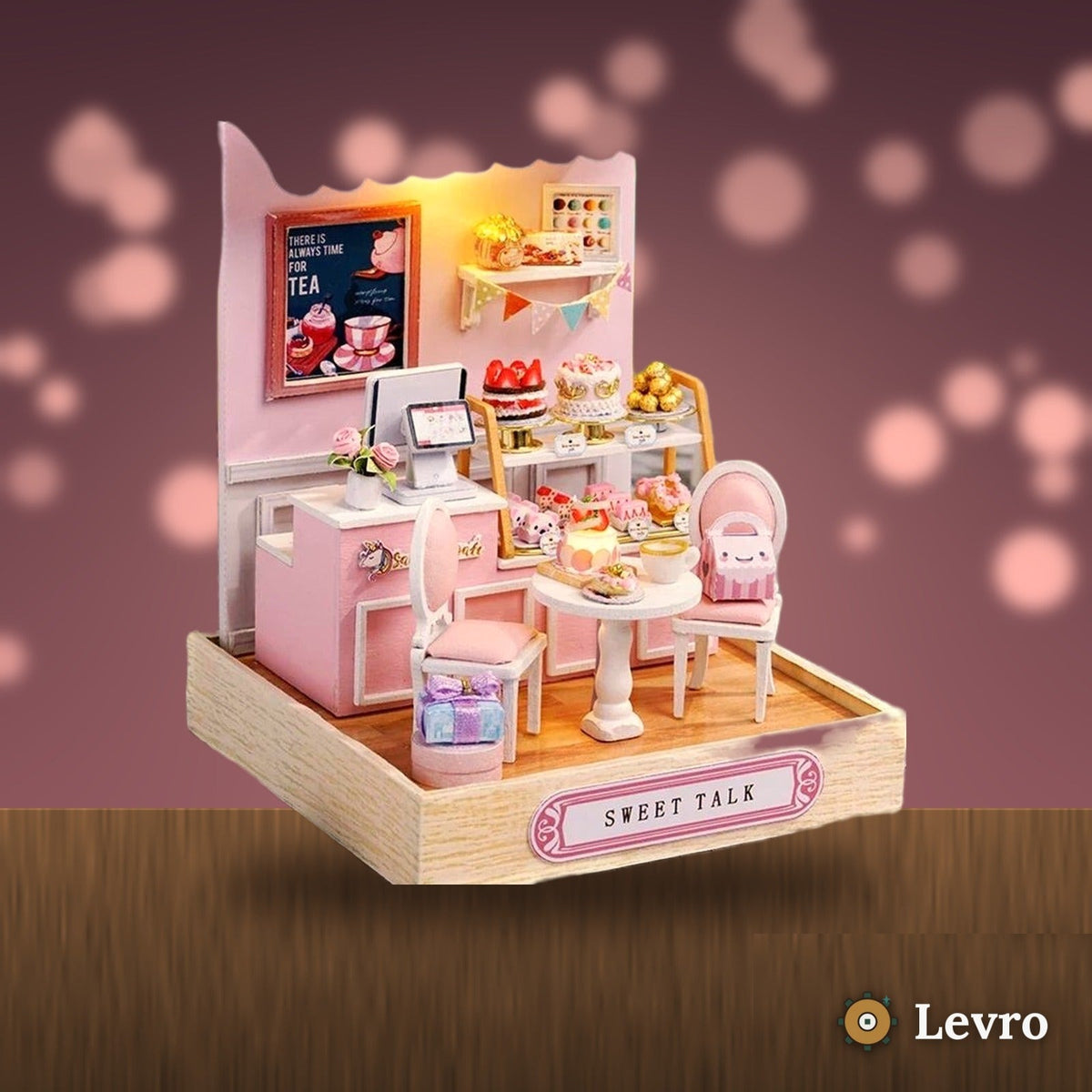 Sweet Cake Shop miniature kit glowing on a cozy shelf at night