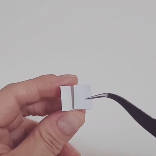 Tiny miniature books in hand